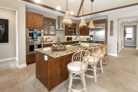 Your gourmet kitchen awaits with granite counters, stainless steel appliances, and a spacious island perfect for morning coffee or evening wine.