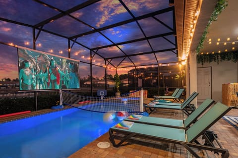 Enjoy a movie by the pool with a stunning lake view
