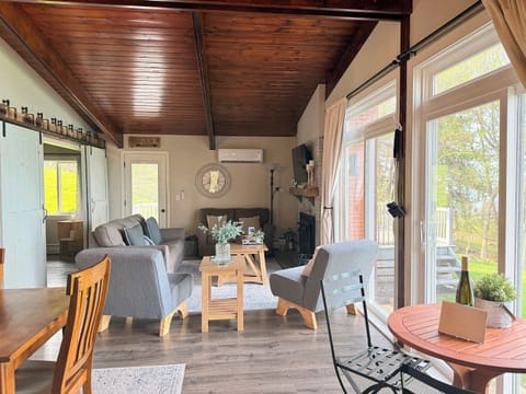 Inviting main living room with vaulted wood ceilings, comfortable seating, and a cozy fireplace.