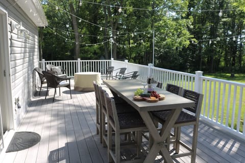 Full deck with dining table seating six, grill, and fire table- a guest favorite