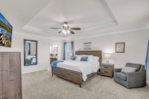 Primary bed with King bed, 65 inch TV, dark out curtains, and private bath.  