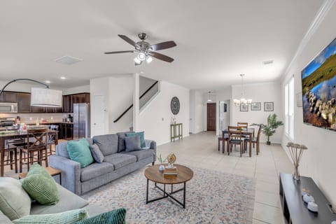 Open concept living room and dinning area with 65 inch TV.