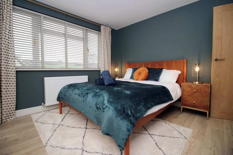 King bedroom with plush bedding, soft lighting and a peaceful atmosphere for restful nights.