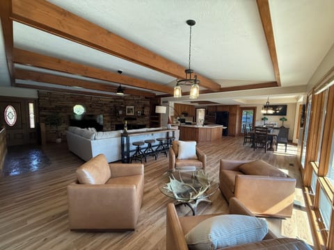 Large open living room, kitchen, and dining room.   2 TVs, lots of seating. 