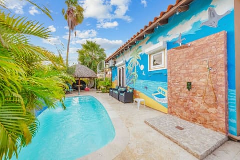 Your private oasis! Cool off in the pool, relax by the colorful mural, and enjoy the convenience of the outdoor stone shower.
