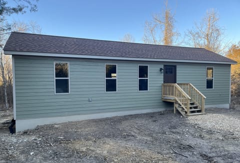 Outside front of cabin. Outside landscaping in progress.