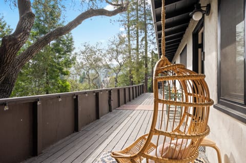 Deck area with hanging chair — perfect for coffee or sunset wine