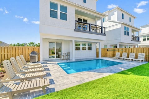 Aqua Sol—your perfect group getaway that SLEEPS 22! Just steps from the beach, this stunning retreat includes a FREE golf cart. Unwind in the backyard oasis with a HEATED pool, outdoor kitchen, and lounge seating.