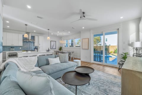 1st Floor - Spacious living room with plush seating and a large Smart TV, designed for large groups to relax together after the beach
