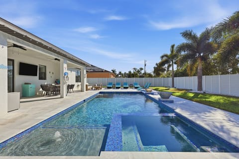Unwind in your private backyard oasis featuring a heated pool, in-pool spa, sun ledge, and a 6’ privacy fence for peaceful relaxation.