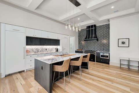 Your chef-worthy kitchen awaits with marble countertops, premium appliances, and pendant lighting creating the perfect culinary sanctuary.