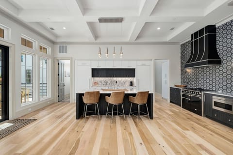 Cook memorable meals in this stunning modern kitchen with premium appliances, spacious island seating, and gorgeous coffered ceilings.