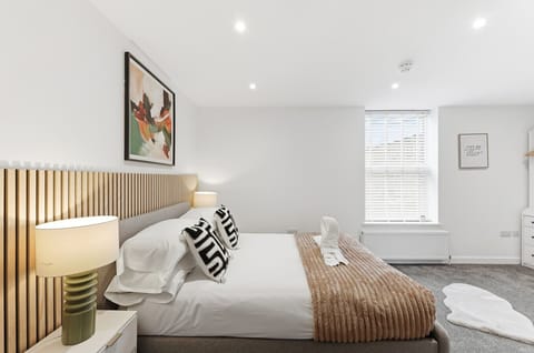 Bedroom one features a double bed with fresh linen and towels provided.