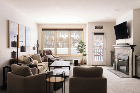 Living area with electric fireplace and TV