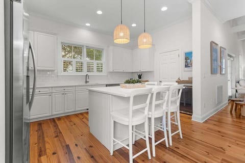 Kitchen opens up to dining room.  Bright, light fully stocked kitchen.