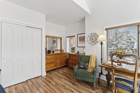 Classic wooden dresser and a comfortable armchair.