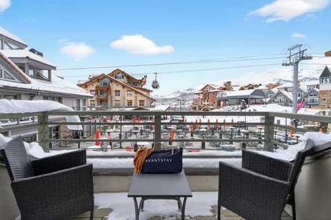 Scenic balcony view of the snowy mountain village and ski lifts.