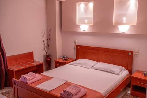 Warm and restful double room setup with fresh towels provided—great for a comfortable stay close to town attractions.