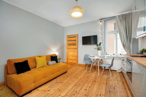 Living room with sofa and dining area.