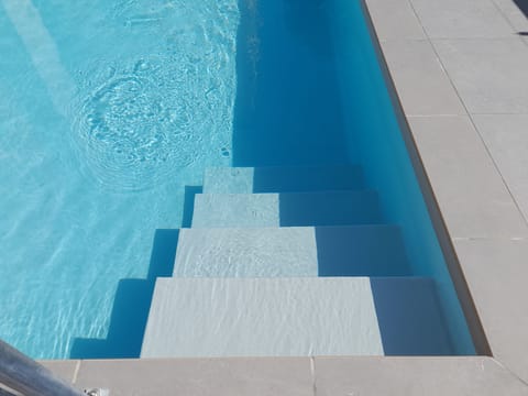 Seasonal outdoor pool, open 9:00 AM to 9:00 PM, pool umbrellas