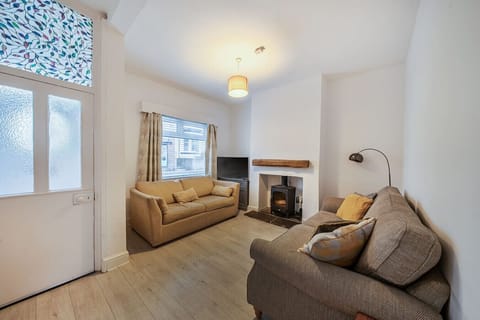 Settle into the living room with two sofas, a fireplace, and TV.