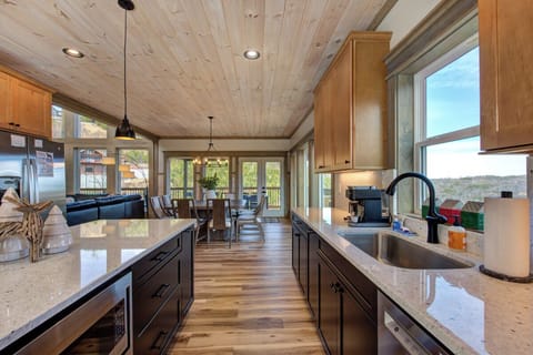 You'll love cooking in this stunning open kitchen with granite counters, stainless appliances, and soaring wood ceilings.