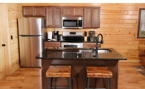 Your fully equipped kitchen features granite counters, stainless appliances, and a breakfast bar perfect for morning coffee.