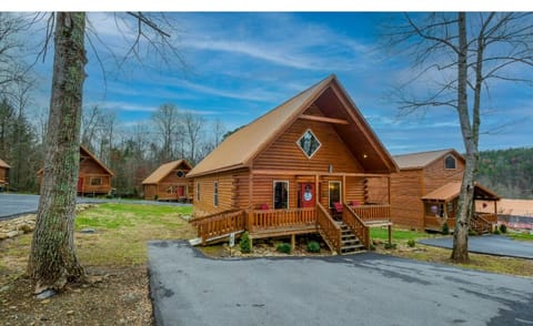 Charming log cabin nestled among mature trees in a peaceful mountain setting with convenient paved access.