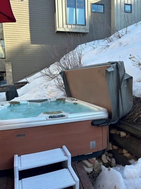 Private outdoor hot tub with snowy mountain-retreat vibes
