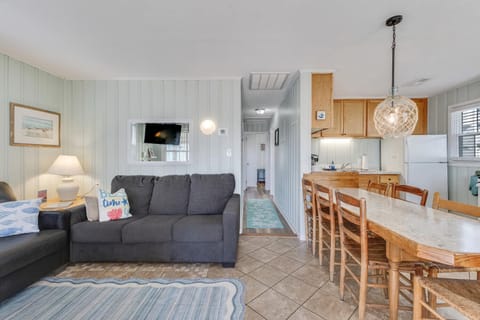 Relax in your bright, coastal-style living space with comfortable seating, full kitchen, and charming nautical touches that create the perfect beach getaway atmosphere.