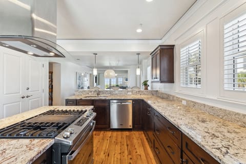 Your gourmet kitchen features granite counters, stainless appliances, and warm wood floors—perfect for cooking memorable vacation meals together.