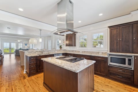 Cook memorable meals in this spacious chef's kitchen featuring granite countertops, premium appliances, and warm wood cabinetry.