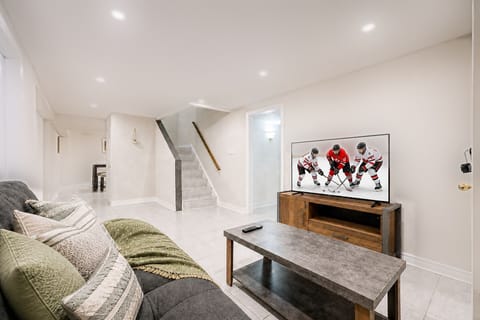 Bright lower-level lounge with cozy seating and TV entertainment