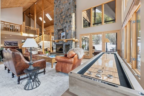 Warm up by the stone fireplace, challenge your crew to a shuffleboard match, and let the evening unfold in this light-filled great room