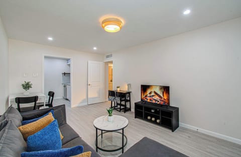 Bright, open-concept living with a plush sectional, dining nook, and dedicated workspace.