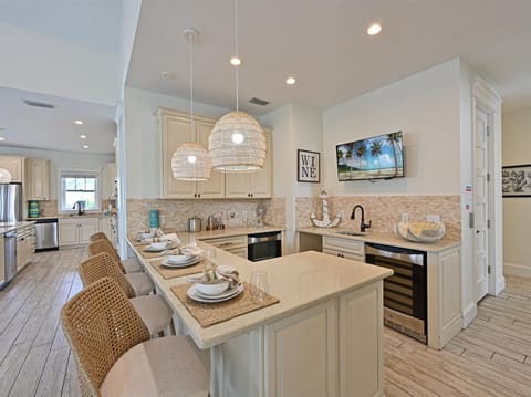 Entertaining bar area with Barstools, wine, fridge, mini fridge, etc.