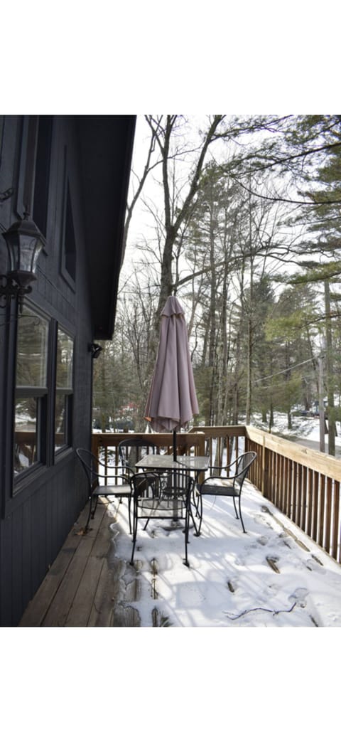 Quad table with umbrella on large deck street facing, perfect for morning coffee