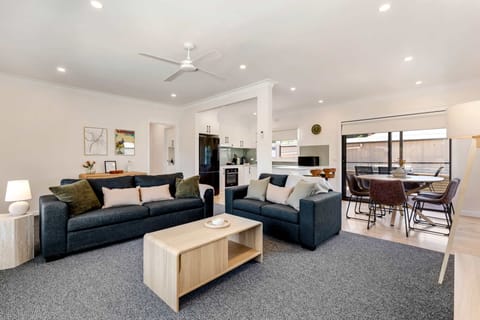 Open-plan living featuring Smart TV, split system heating and cooling and ceiling fan for year-round comfort.