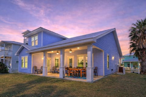 Rear view of the house and spacious backyard & patio.