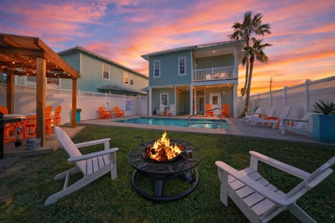 Sun-soaked backyard with a private pool, fire pit lounge, and pergola dining—your perfect Port A hangout from day to night.