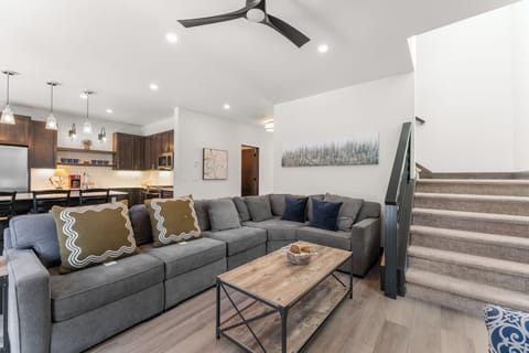 Living area with a remote control gas fireplace, mounted TV, and access to the hot tub patio.