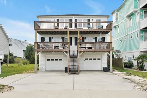 Multi-level beach house featuring expansive decks and convenient ground-level parking in a quiet coastal neighborhood.