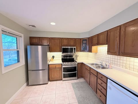 Full kitchen with dining table and deck access