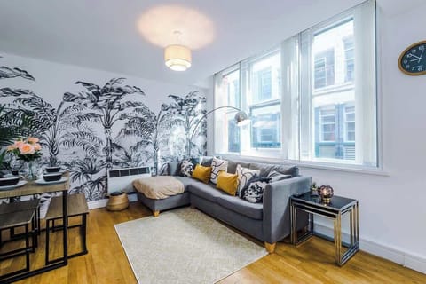 Living Room: Bright and stylish space with vibrant décor and stunning city views! Perfect for relaxation.