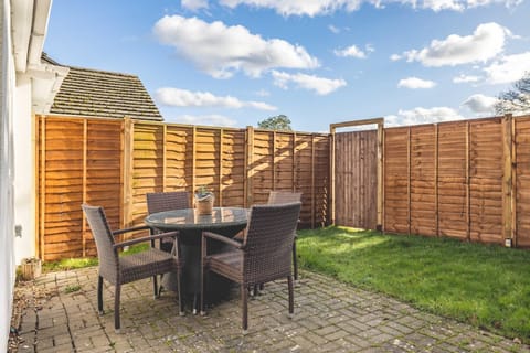 Outdoor Patio: Enjoy al fresco dining in a charming garden setting under the blue skies!