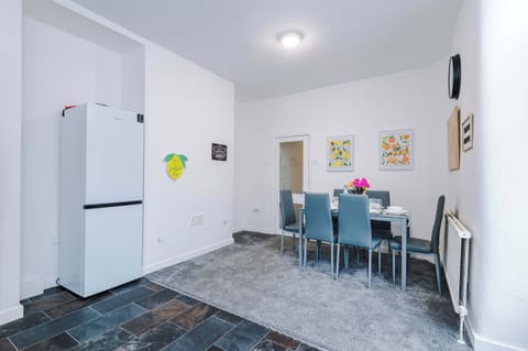 Dining Room: Bright and airy space with cheerful decor, perfect for meals and laughter with friends!