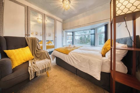 Bedroom Retreat: Bright room with modern decor, plush bedding, and garden views for pure relaxation!