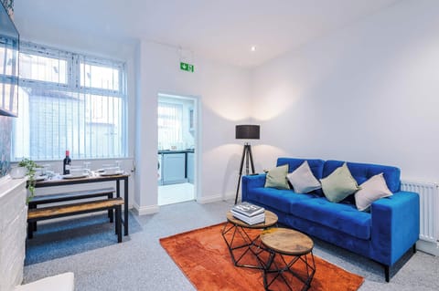 Living Room: Bright space with stylish blue sofa, perfect for relaxation and gatherings!