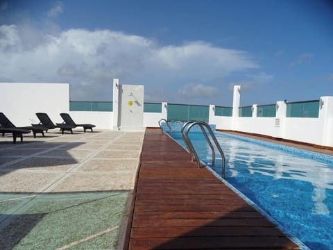 Stretch out on loungers beside the sparkling rooftop pool.