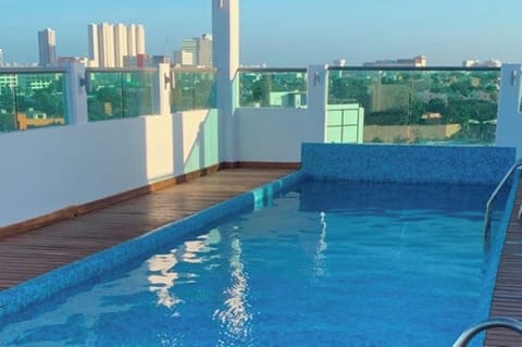 Cool off with a refreshing dip in the sunlit pool.